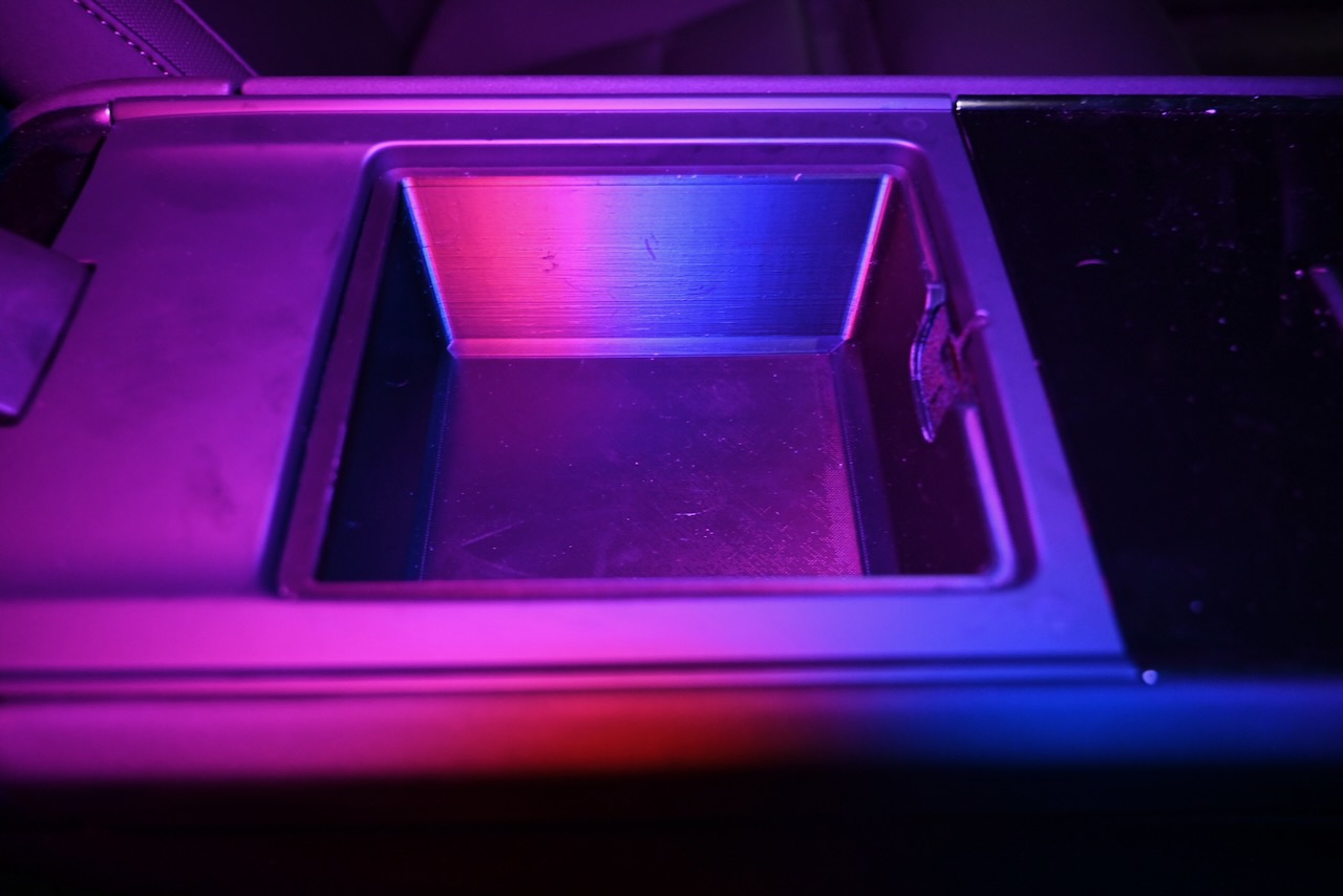 An armrest bucket for a Polestar 3 in colored light